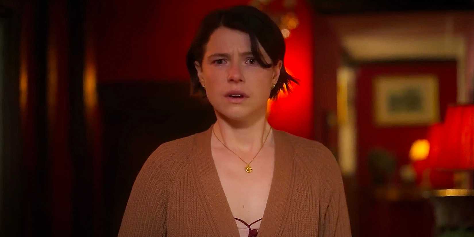 Harper (Jessie Buckley) stands in a hallway looking petrified of something. 