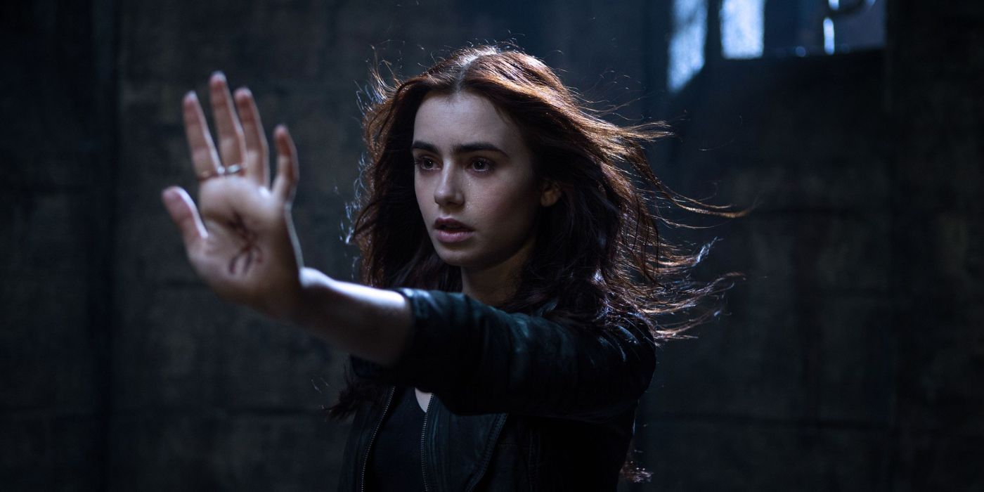 Clary, played by Lily Collins, stretching her hand out in The Mortal Instruments: City of Bones