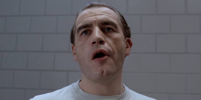 Hannibal Lektor inside his cell with his mouth open in Manhunter