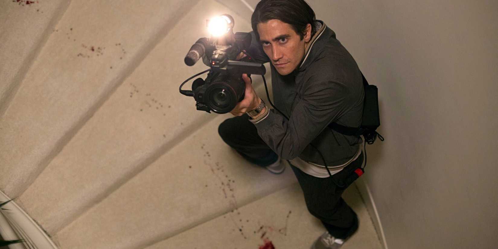 Lou aims his camera up while climbing a set of stairs in the film Nightcrawler