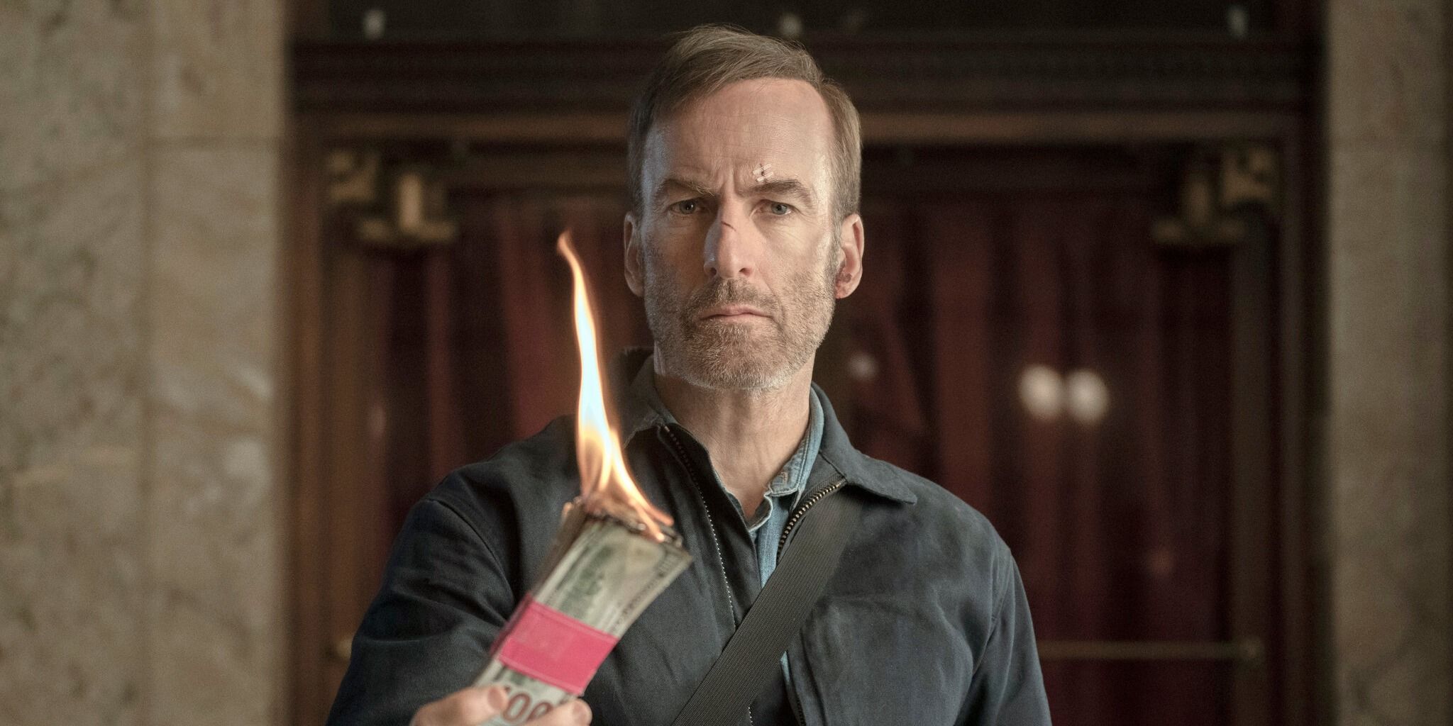 A man holding money that's on fire in Bobody
