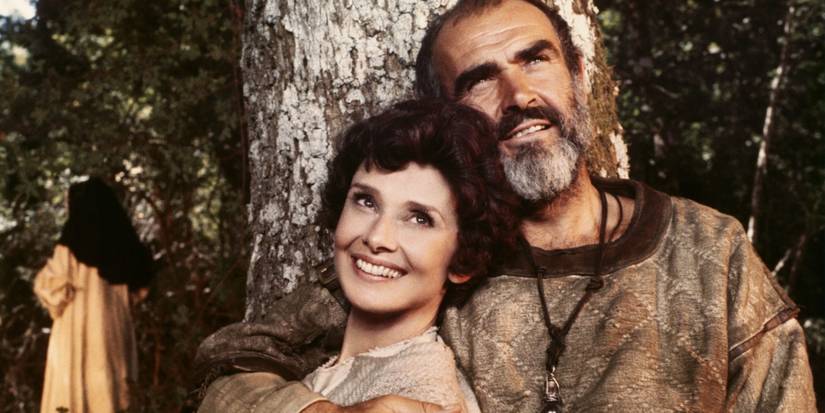 Robin Hood and Maid Marian smiling while sitting under a tree in Robin and Marian.