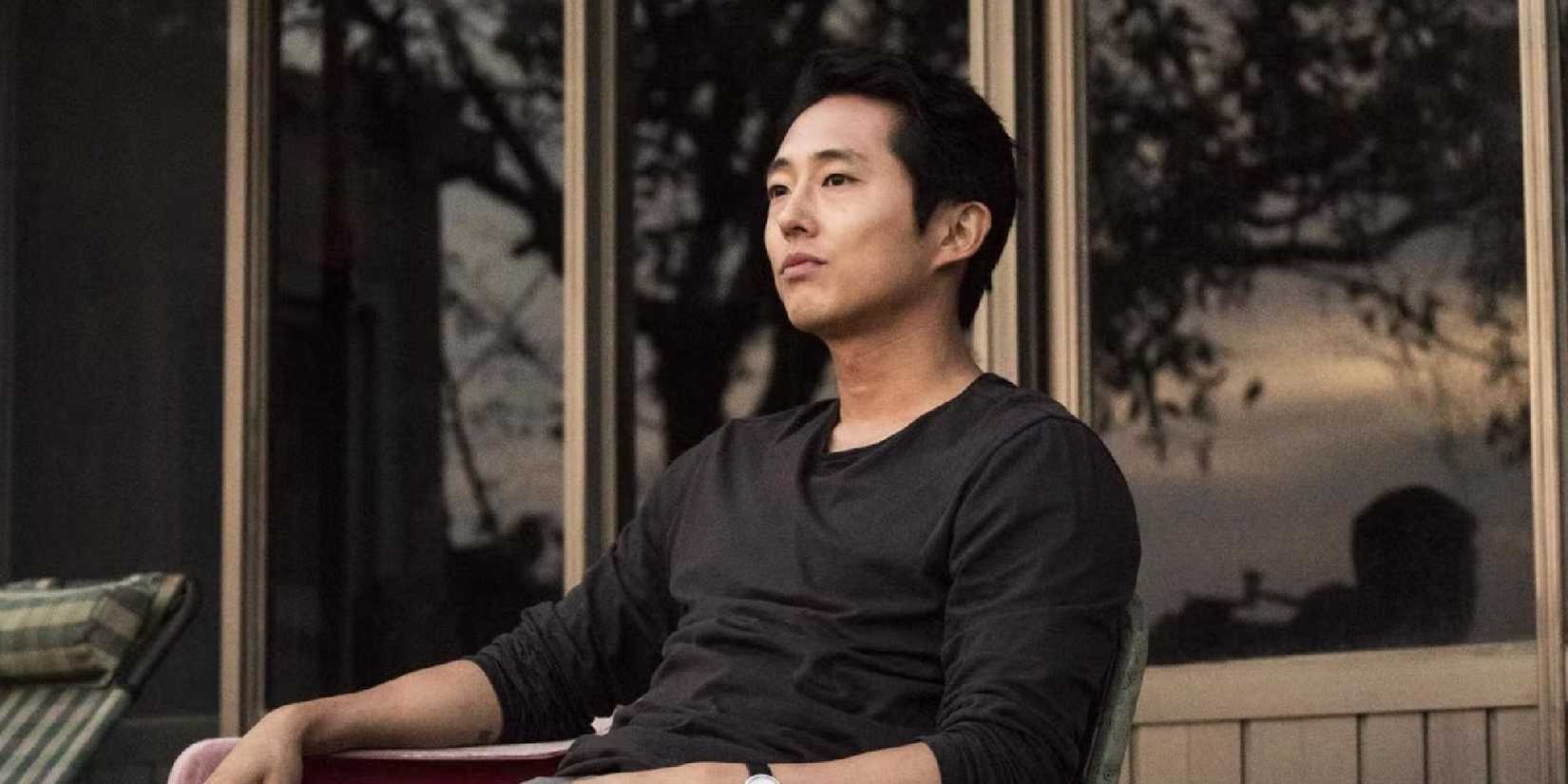 Steven Yeun sitting down in his yard in Burning.