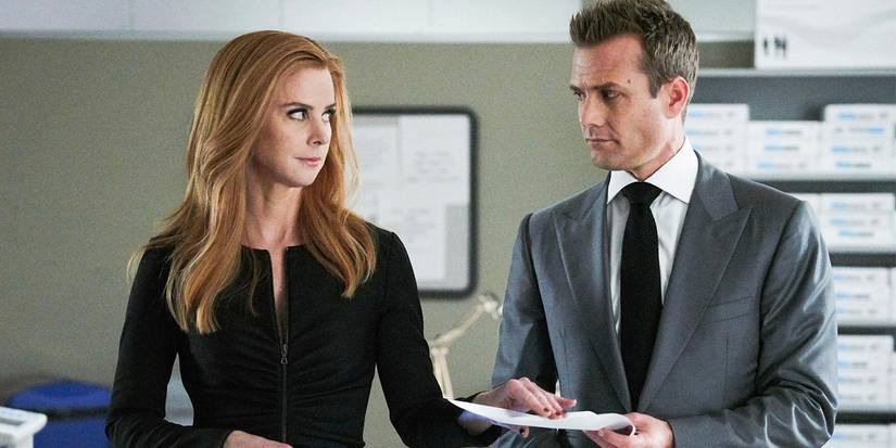 Donna handing Harvey a piece of paper in a scene from Suits.