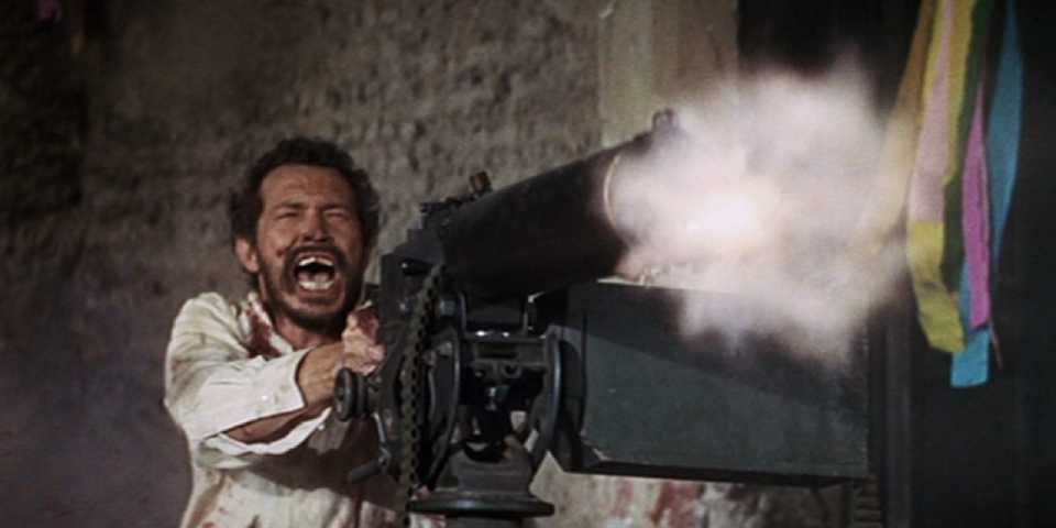 A man yelling while firing a machien gun in The Wild Bunch - 1969 (1)