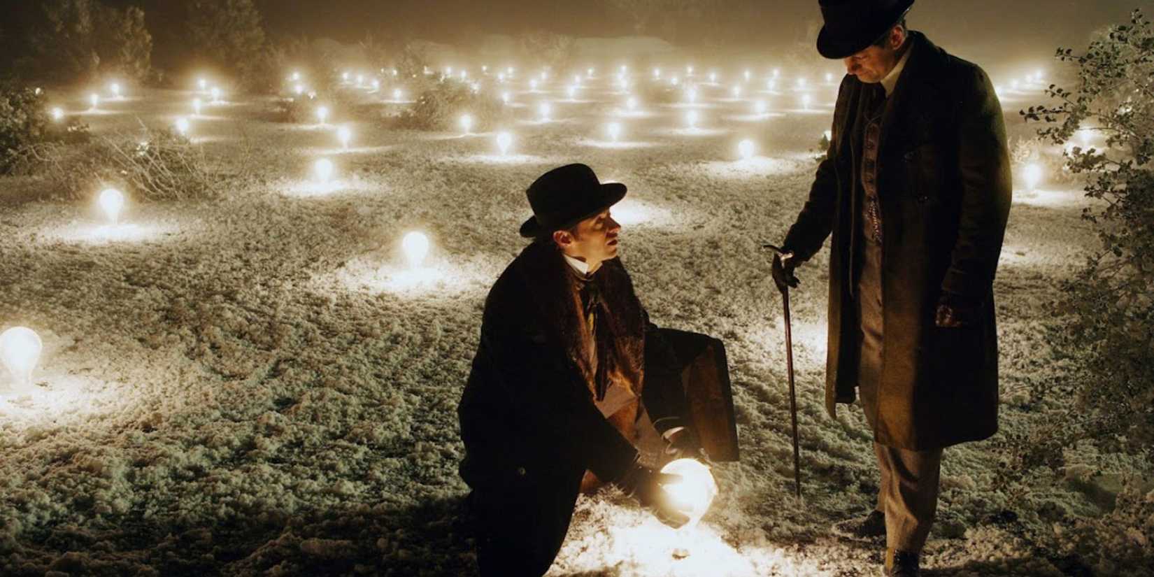 Angier (Hugh Jackman) and Tesla’s assistant (Andy Serkis) stand in a field of lights in 'The Prestige'.