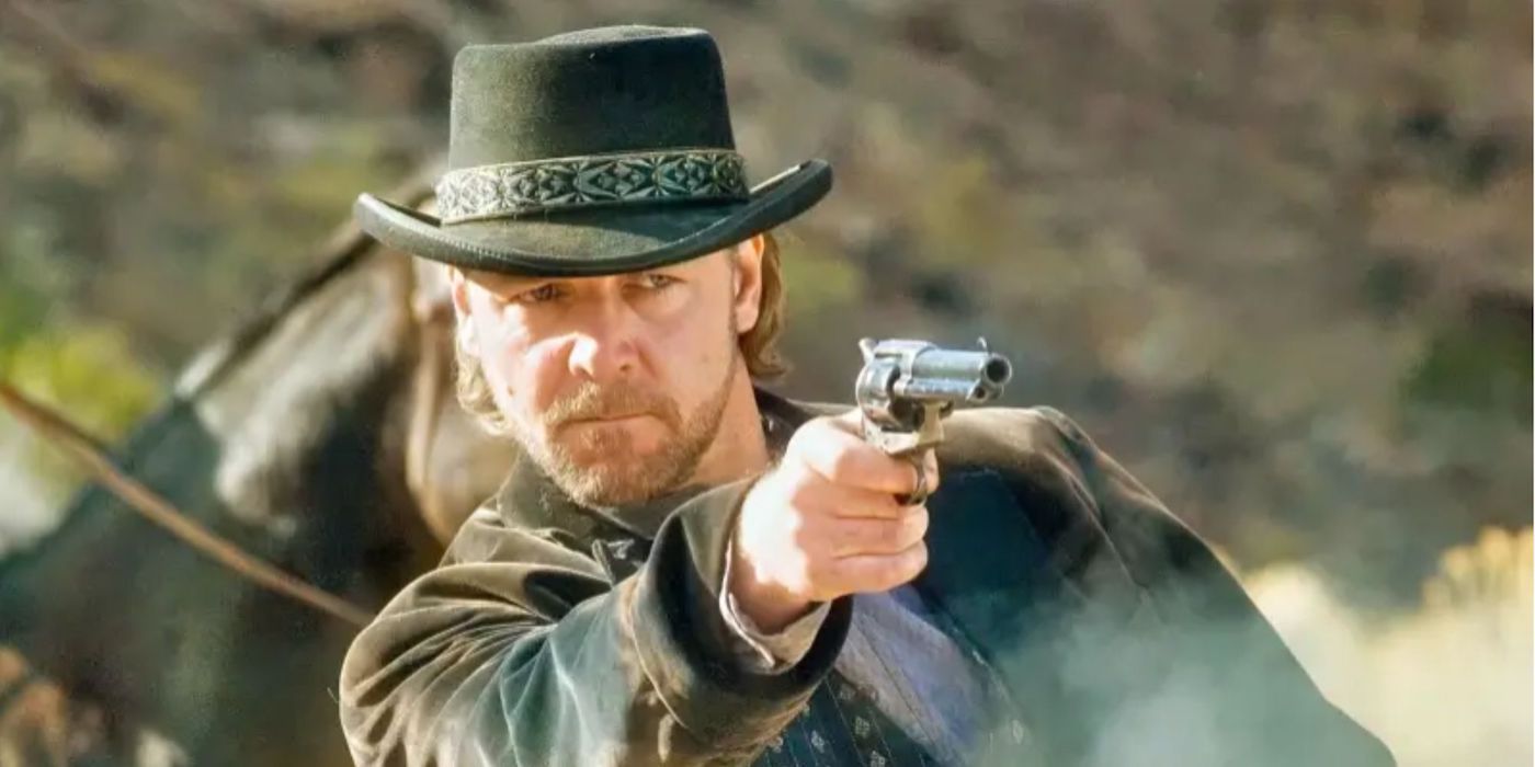 Outlaw gunslinger Ben Wade (Russell Crowe) aims his revolver in a field in '3:10 to Yuma.'