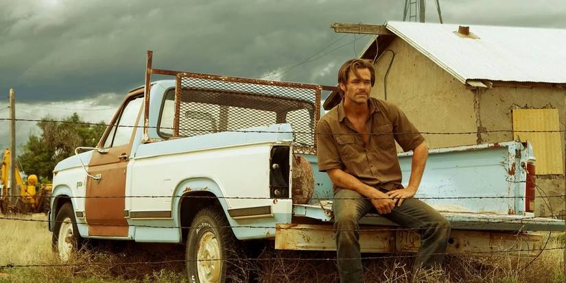 Chris Pine as Toby Howard sitting on his truck in 2016's Hell or High Water