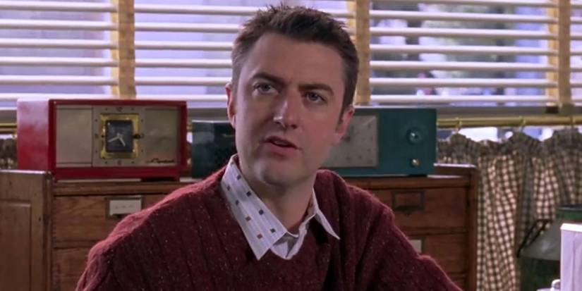 Sean Gunn as Kirk, sitting at a table in Luke's Diner on Gilmore Girls