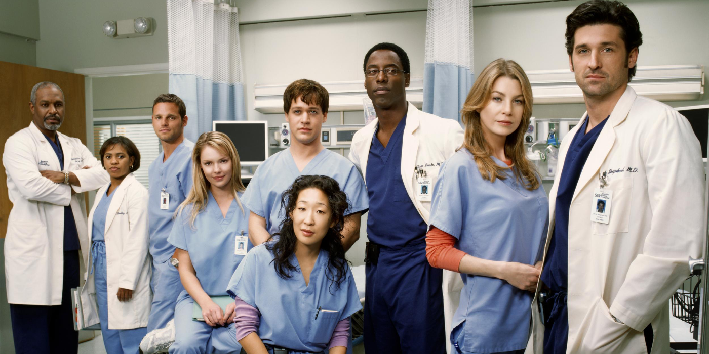 Promotional photo of the Season 1 cast of Grey's Anatomy, including Ellen Pompeo, Patrick Dempsey, Sandra Oh, abd T.R. Knight.