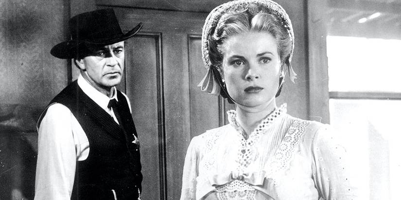 Gary Cooper as Will Kane and Grace Kelly as Amy Kane standing together in High Noon