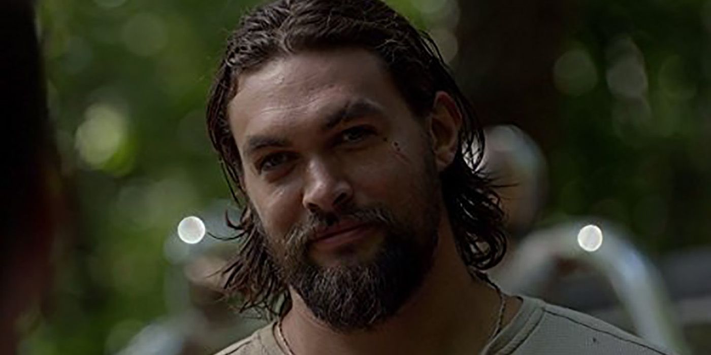 A close up of Jason Momoa with short, slick-backed hair smiling in The Red Road.