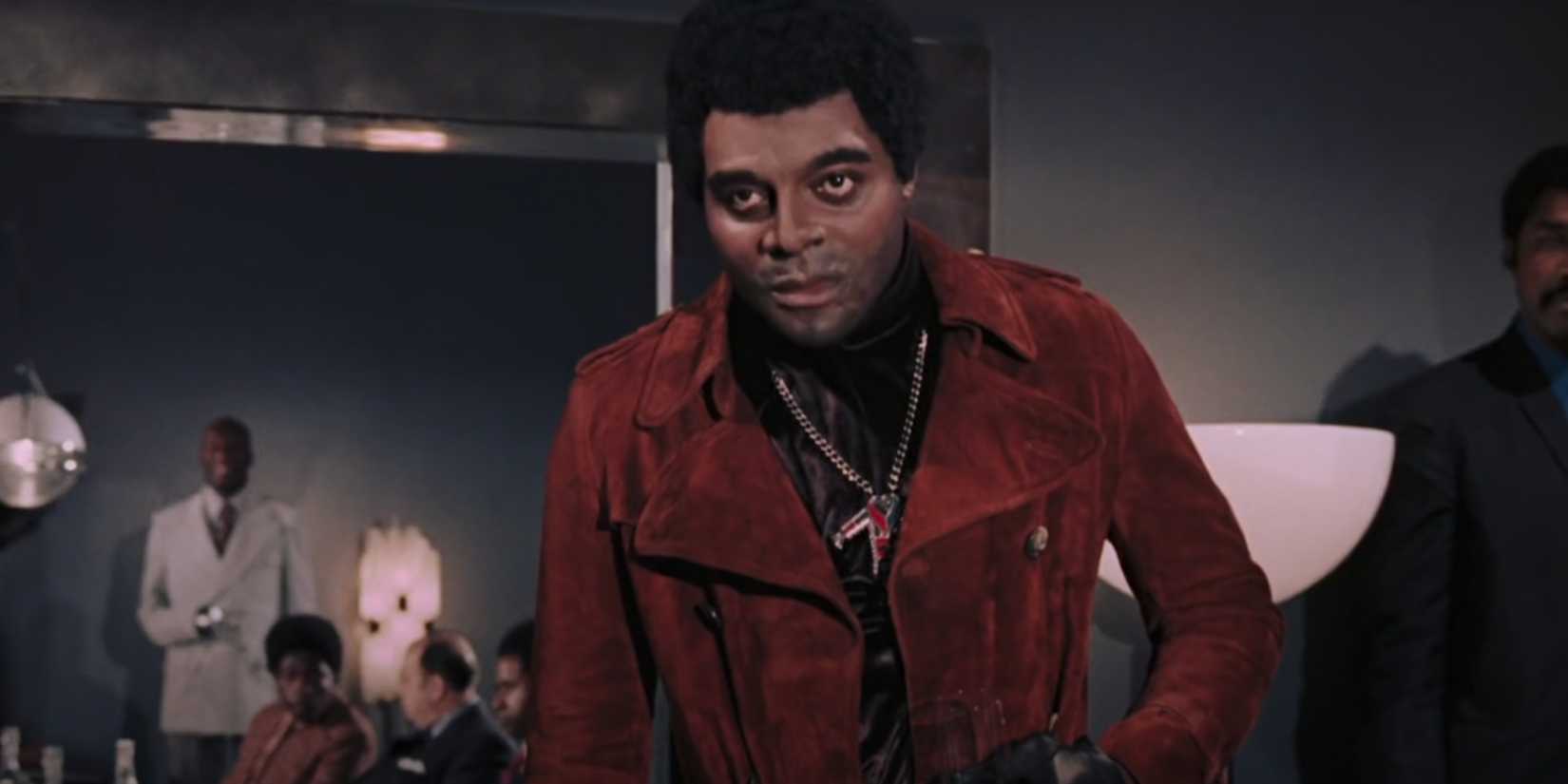 Dr. Kananga emerges from his office to order James Bond's death and get a drink. 