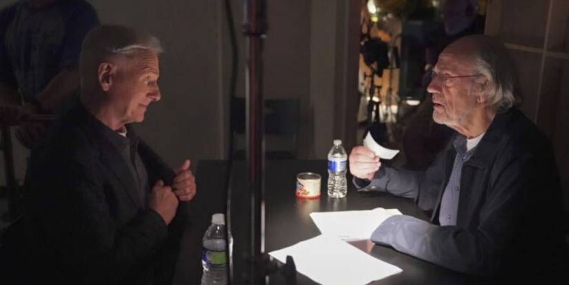 Mark Harmon sitting across a table from Christopher Lloyd in NCIS