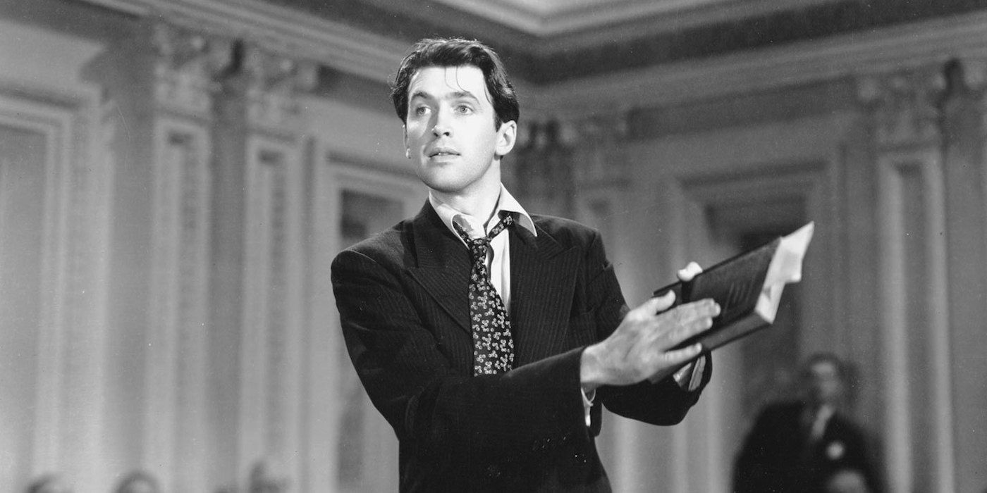 Jefferson Smith holding a book at court in Mr. Smith Goes to Washington