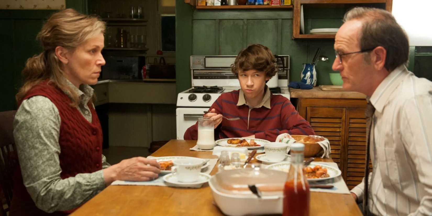 Frances McDormand as Olive Kitteridge and Richard Jenkins as Henry Kitteridge stare at each other across the dining table in 'Olive Kitteridge' (2014).