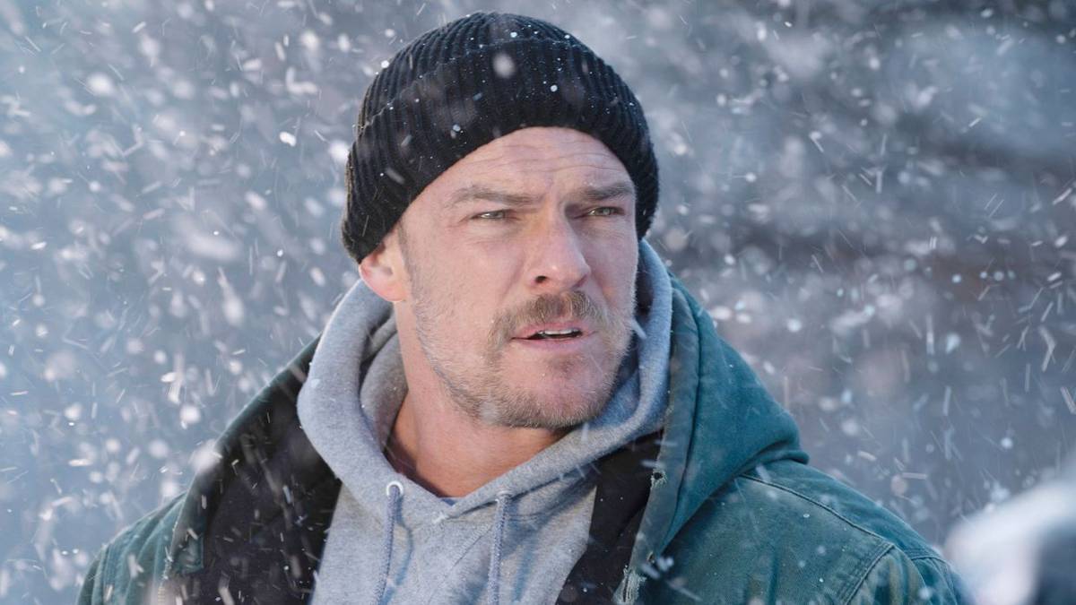 Alan Ritchson in the snow in Ordinary Angels