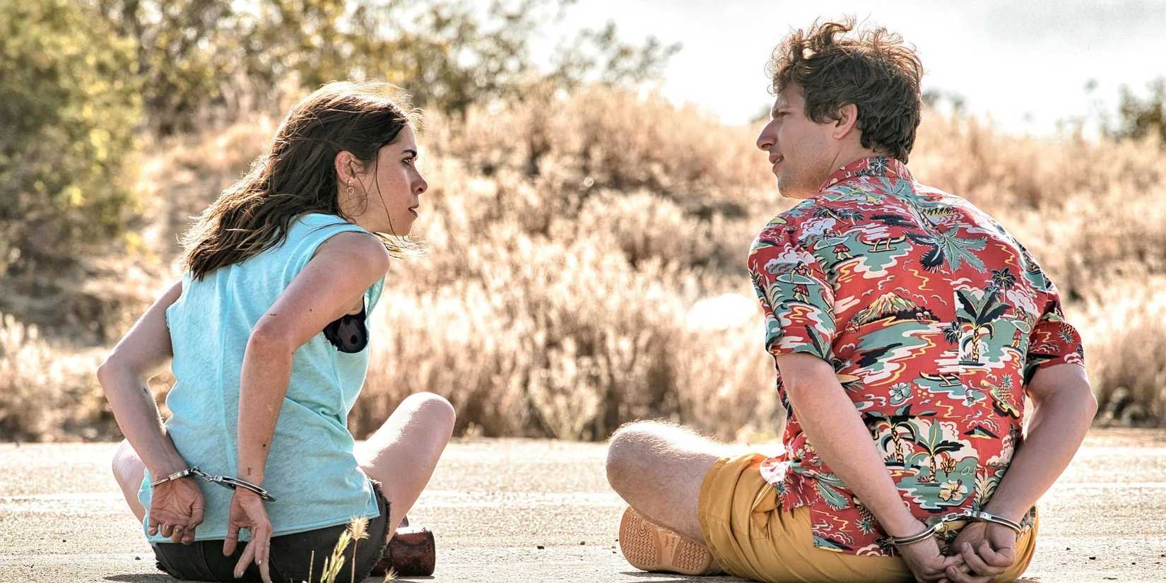 Nyles and Sara handcuffed and sitting in the middle of a desert road in Palm Springs (2020).