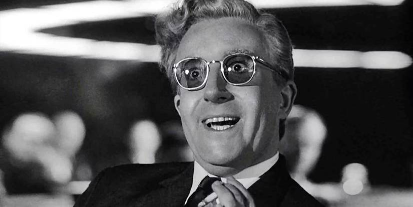 Peter Sellers as Dr. Strangelove smiling widely in Dr. Strangelove