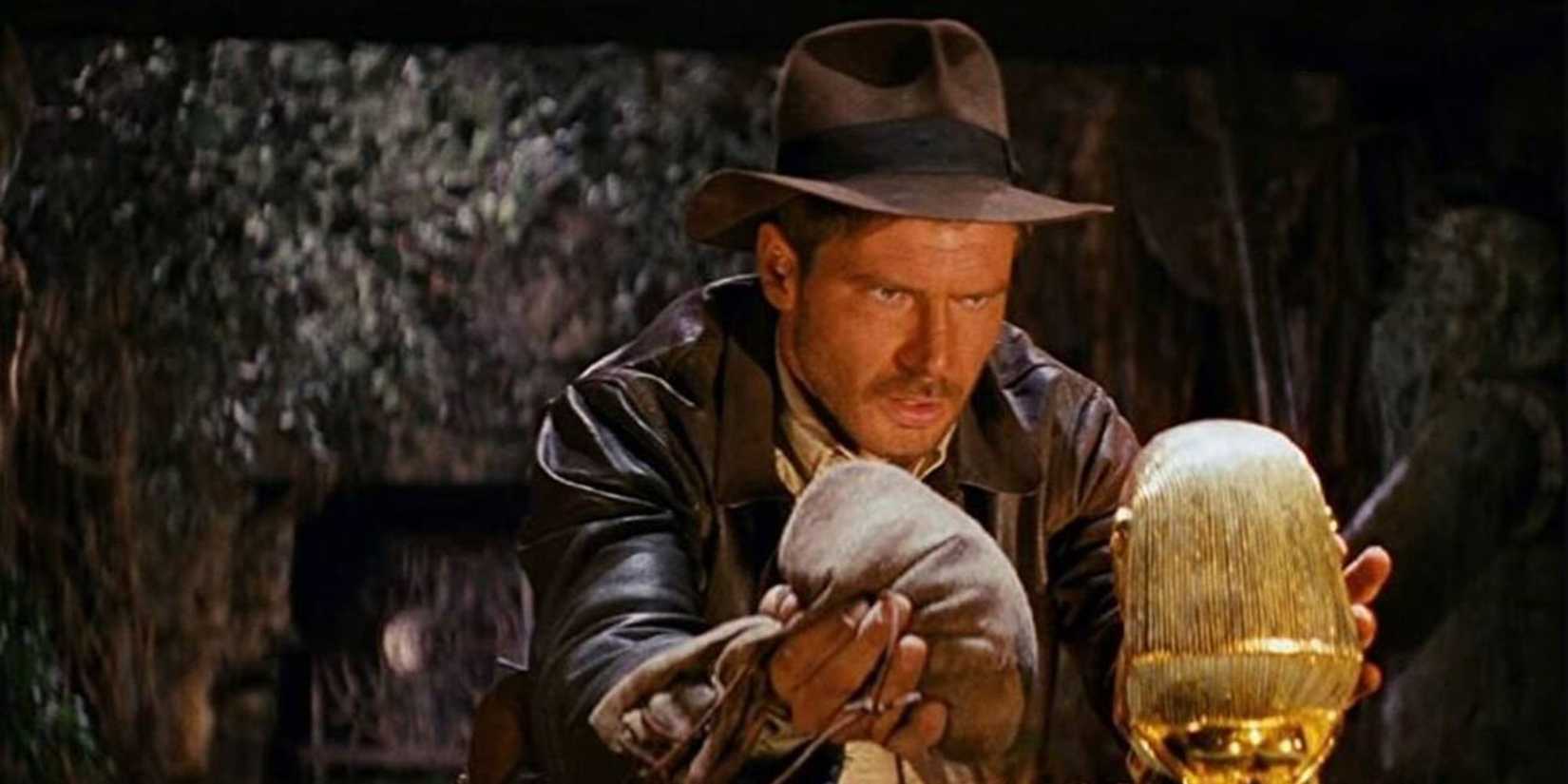 Indiana Jones preparing to replace a golden statue with a bag of sand in Raiders of the Lost Ark’ 
