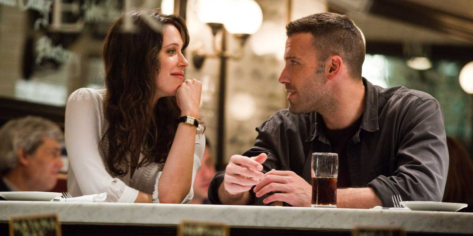 Ben Affleck and Rebecca Hall flirt at a restaurant table in 'The Town'.
