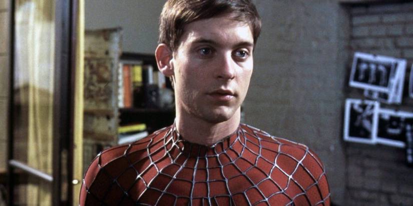 Peter Parker with his mask off looking intently off-camera in Spider-Man (2002)