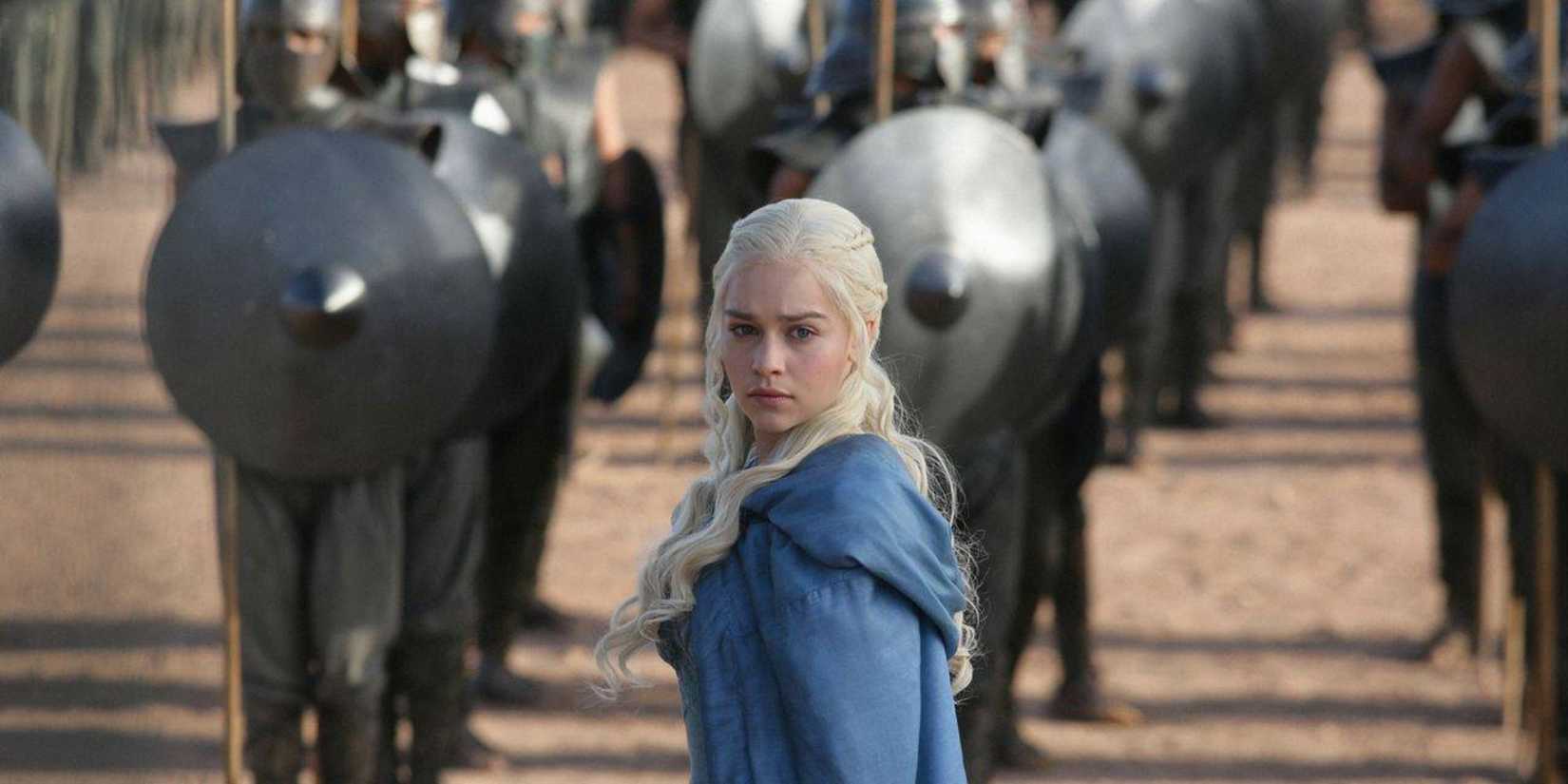 Daenerys Targaryen stands in a blue cloak before a legion of the Unsullied.
