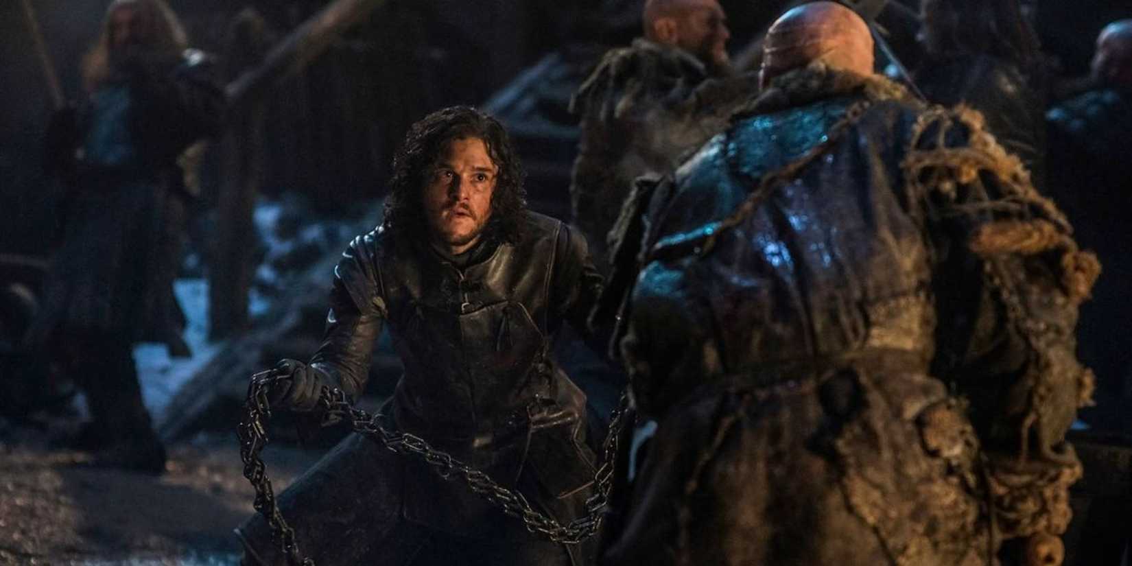 Jon Snow fighting a wildling man in Game of Thrones.