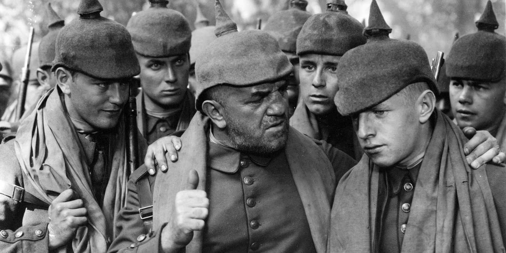 Cast members of All Quiet on the Western Front’ (1930) try to encourage a young soldier