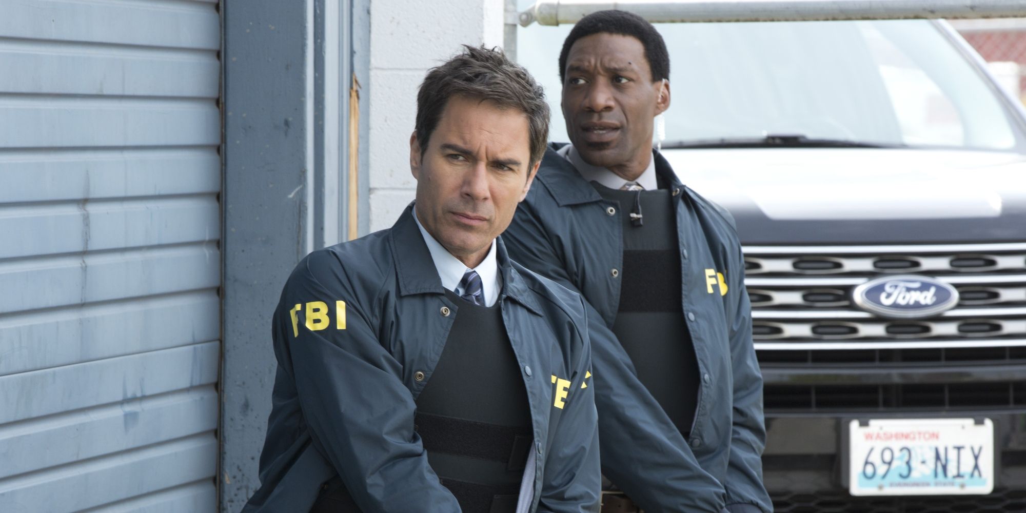Arnold Pinnock and Eric McCormack in Travelers wearing FBI uniforms.