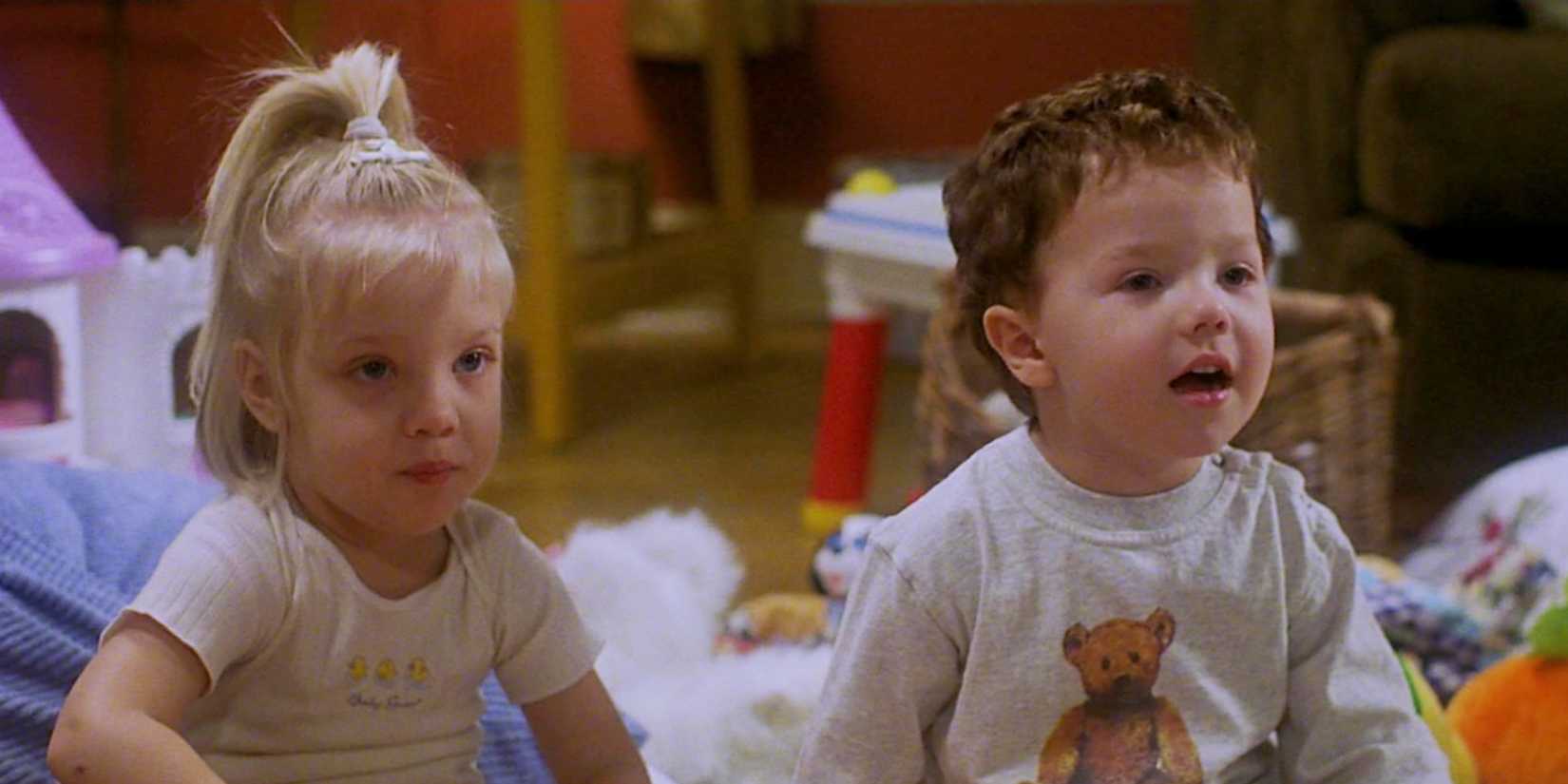 Two young toddlers sit next to each other with toys in the background in Baby Geniuses.