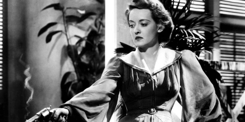 Bette Davis handing out a piece of paper in 'The Letter'