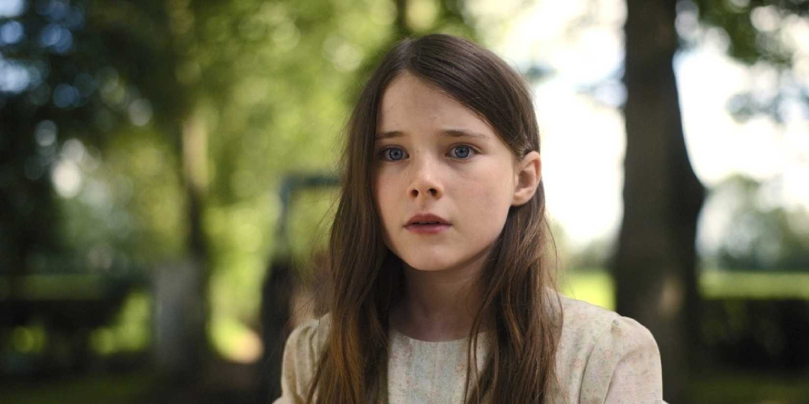 A young girl looking played by Catherine Clinch scared in The Quiet Girl