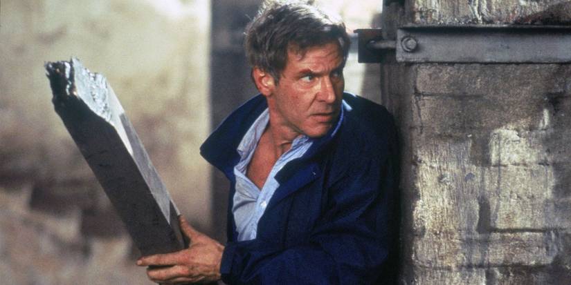 Harrison Ford as Jack Ryan taking cover behind a wall in Clear and Present Danger.
