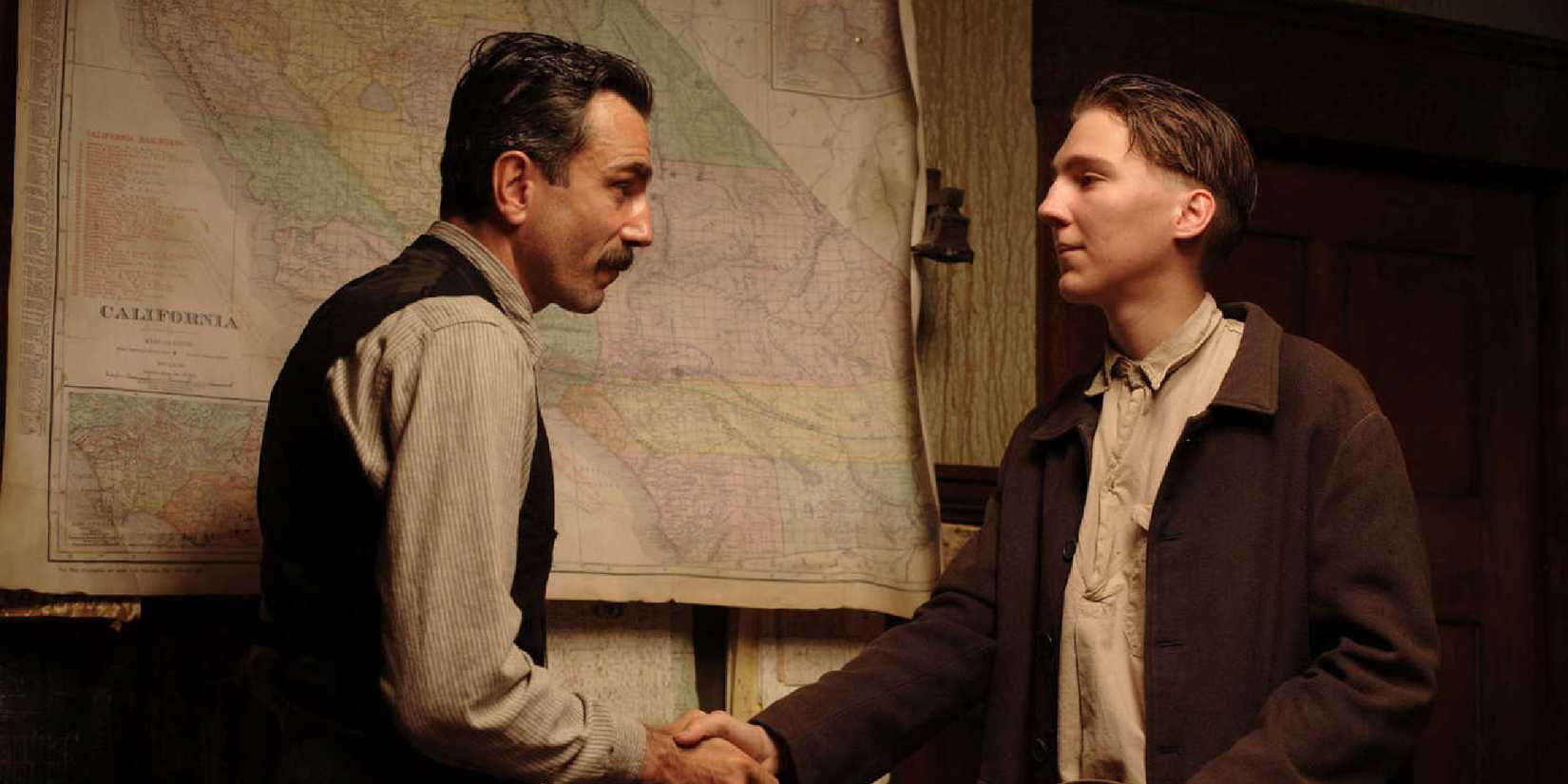 Daniel Day-Lewis and Paul Dano shaking hands in There Will Be Blood.
