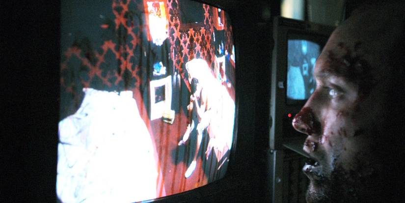 A bloody man watches a TV monitor in the Channel 4 miniseries, 'Dead Set.'