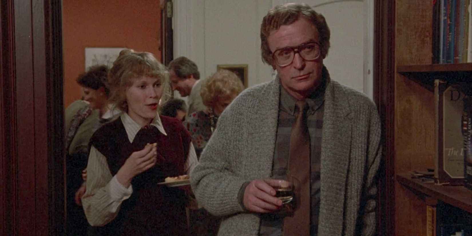 Elliot looking intently ahead at a party in Hannah and Her Sisters - 1986