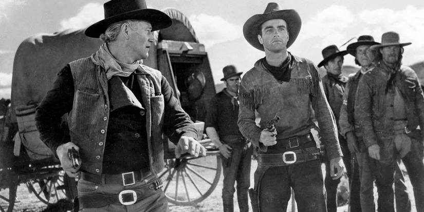 John Wayne as Thomas Dunson and Montgomery Clift as Matthew Garth holding pistols in Red River