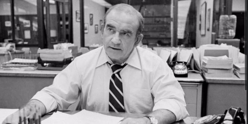 Lou Grant Played by Ed Asner looking on from his desk.