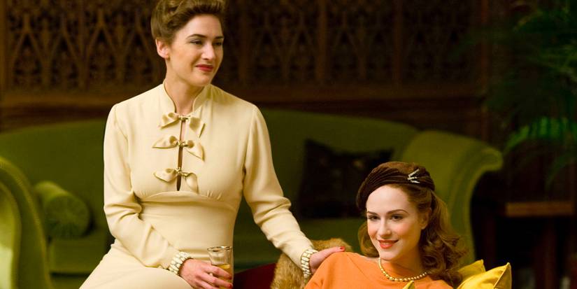 Mildred Pierce (Kate Winslet) and Veda Pierce (Evan Rachel Wood) sit and smile in Todd Haynes' 'Mildred Pierce' (2011).