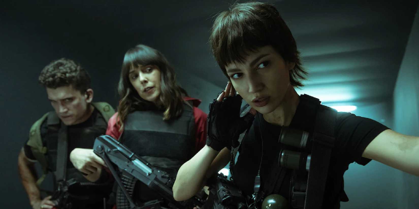 Úrsula Corberó from Money Heist listening to an earpiece with two people behind her