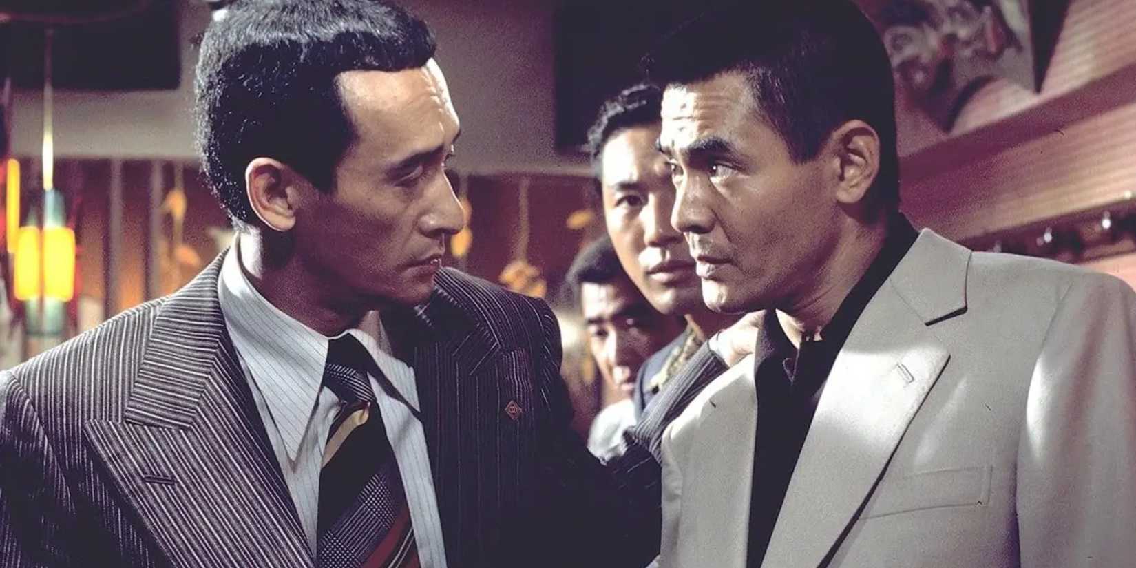 Three men talking in Battles Without Honor and Humanity