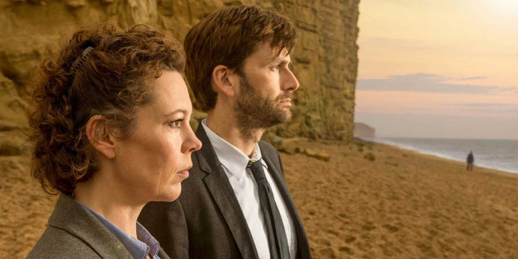 Detectives Hardy and Miller look out toward the horizon standing on a beach in Broadchurch.