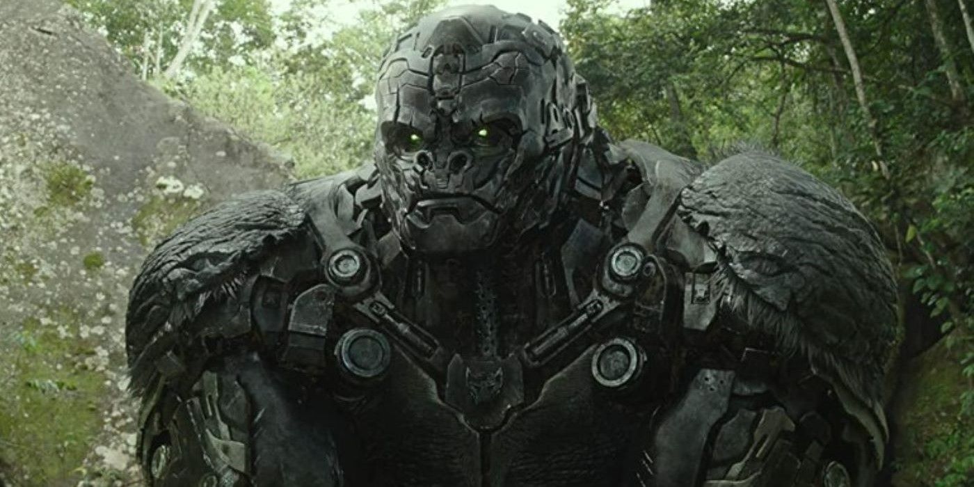 Optimus Primal stands in a wooded area in Transformers Rise of the Beasts