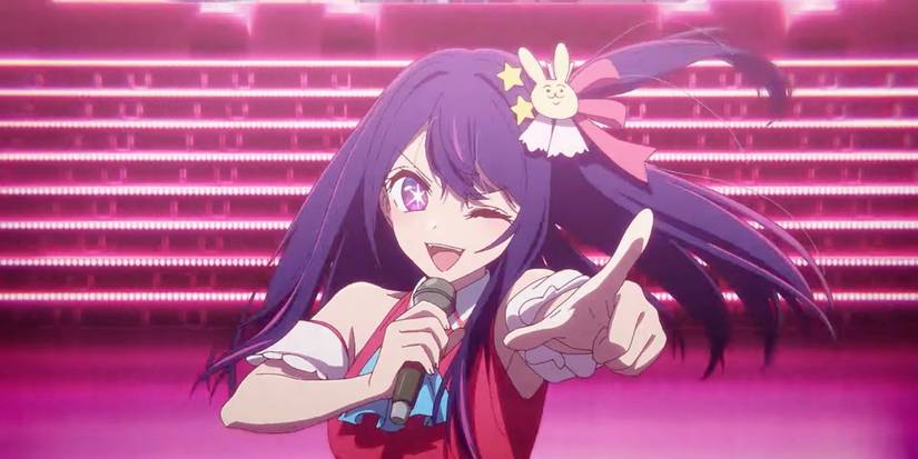 Ai Hoshino (voiced by Rie Takahashi) singing on stage and pointing at the audience in Oshi no Ko