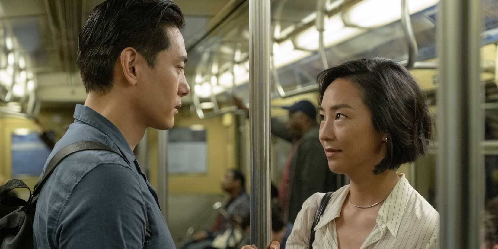 Nora and Hae Sung looking at each other on a train in Past Lives.