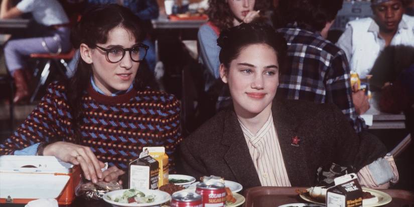 Two young girls having lunch in a school cafeteria in the TV show Square Pegs.