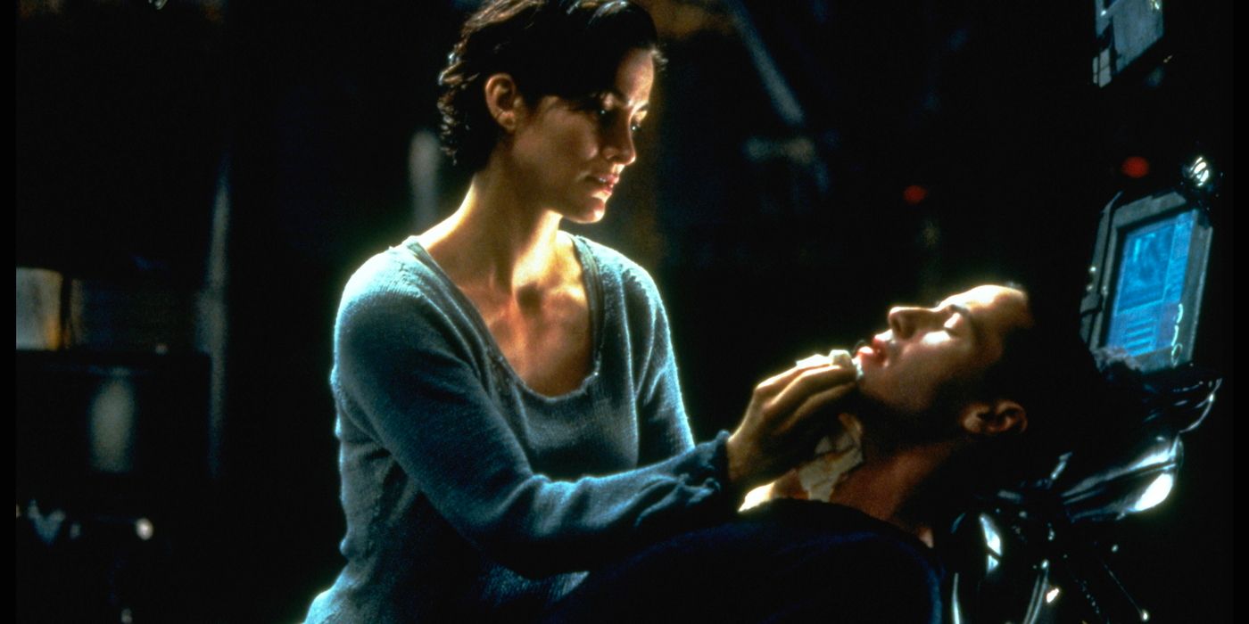 Trinity wipes Neo's chin while he reclines on the ship.