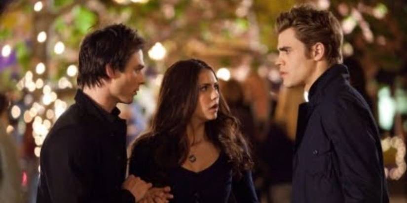 Damon, Elena, and Stefan concerned in the town square in 'The Vampire Diaries' Season 1.