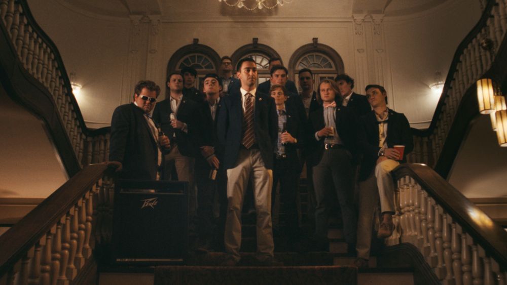 Alex Wolff and Lewis Pullman as fraternity brothers on stairs in The Line